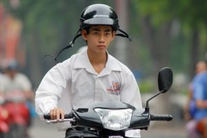 Người đi xe máy không đội nón bảo hiểm vi phạm an toàn giao thông